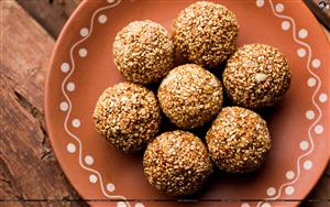 Makar Sankranti special sweet Tilgul Laddus - made up of sesame, crushed peanuts & jaggery